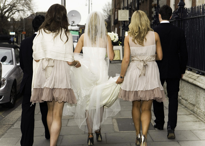 bridal party walking through street